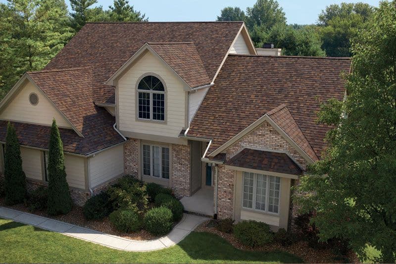 Brown two story house with brown shingles