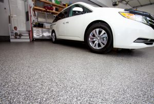 A car parked in a newly coated garage floor.