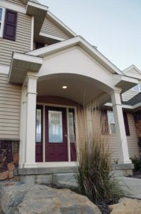 Attractive Home With a Maroon-Colored Entry Door